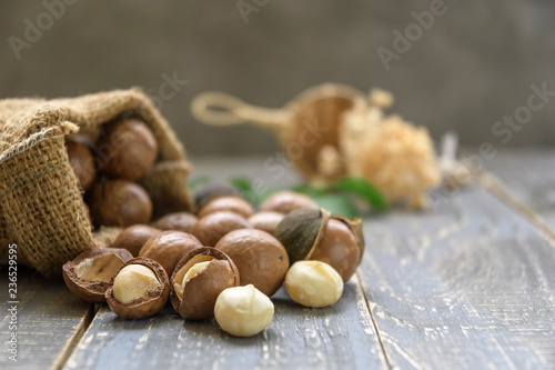 Organic Macadamia nut on wooden table - vintage filter.