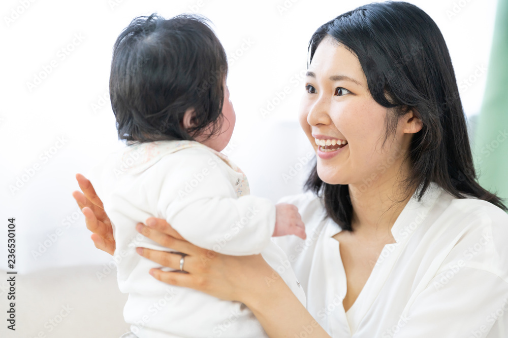 portrait of young asian mother and baby relaxing in living room portrait of young asian mother and baby relaxing in living room