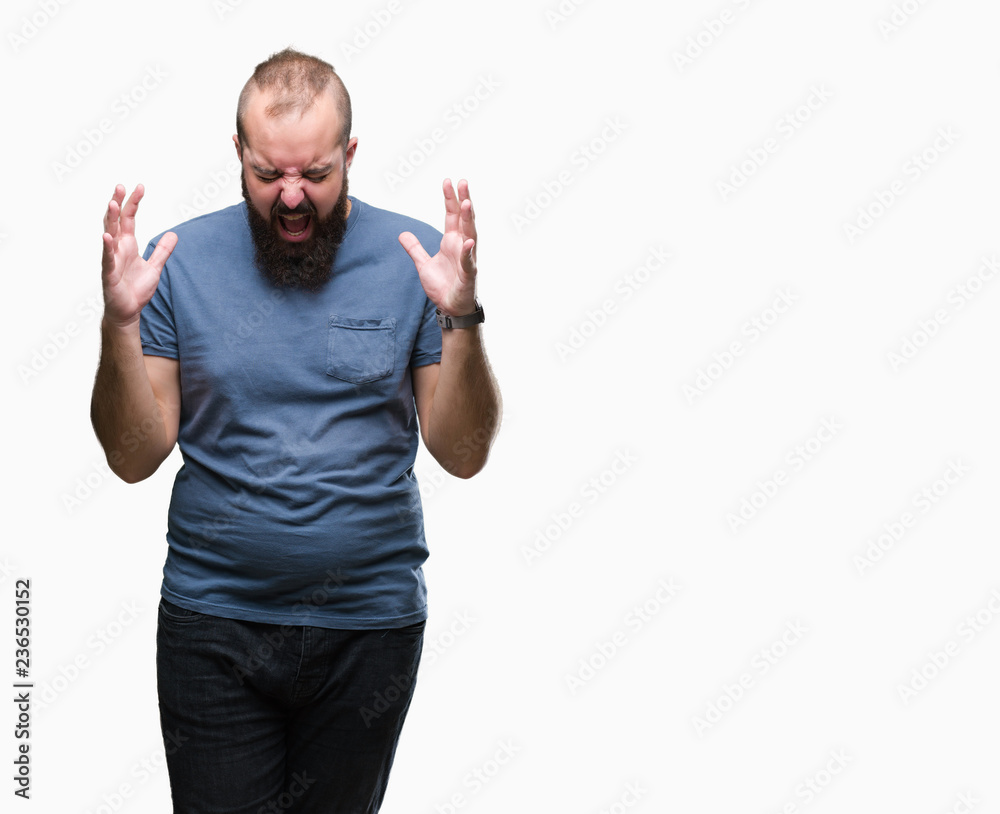 Young caucasian hipster man over isolated background celebrating mad and crazy for success with arms raised and closed eyes screaming excited. Winner concept Young caucasian hipster man over isolated background celebrating mad and crazy for success with arms raised and closed eyes screaming excited. Winner concept