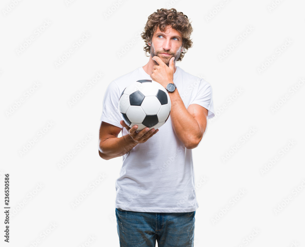 Handsome hispanic man model holding soccer football ball over isolated background serious face thinking about question, very confused idea Handsome hispanic man model holding soccer football ball over isolated background serious face thinking about question, very confused idea