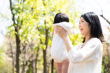 portrait of young asian mother and baby in park