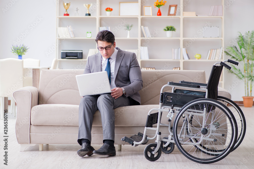 Dsabled businessman on wheelchair working home Dsabled businessman on wheelchair working home