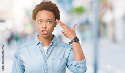 Foto Young beautiful african american woman over isolated background Shooting and killing oneself pointing hand and fingers to head, suicide gesture