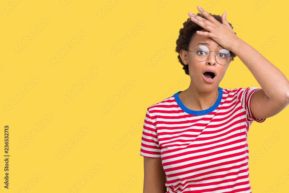 Beautiful young african american woman wearing glasses over isolated background surprised with hand on head for mistake, remember error. Forgot, bad memory concept. Beautiful young african american woman wearing glasses over isolated background surprised with hand on head for mistake, remember error. Forgot, bad memory concept.