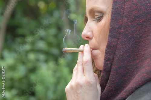 Woman Smoking Marijuana or Cannabis Outside