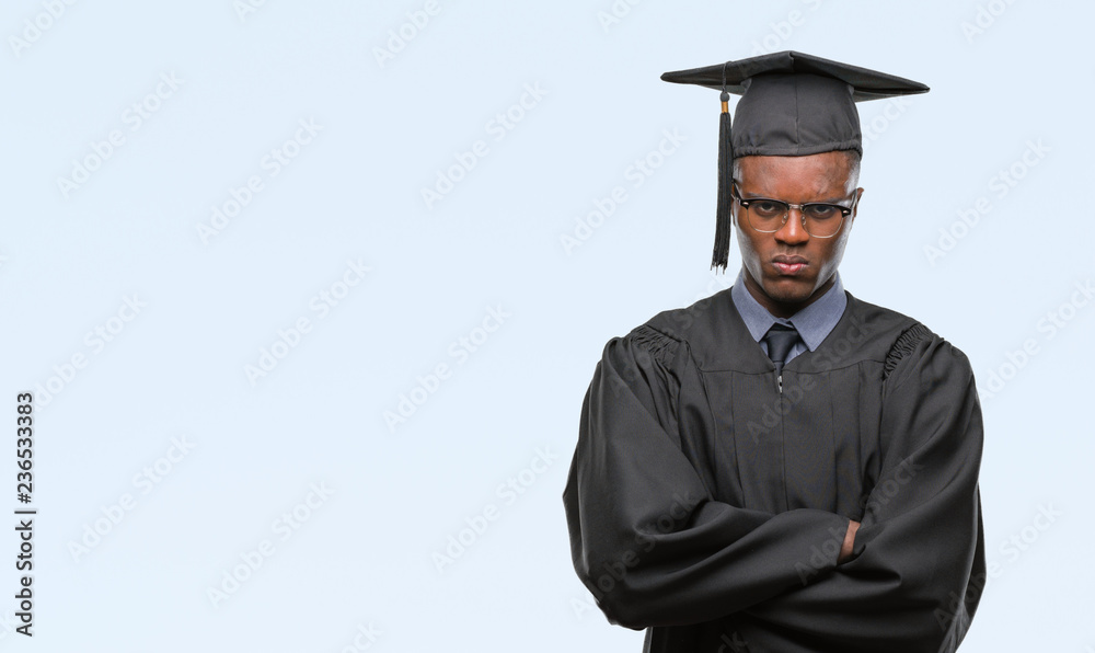 Young graduated african american man over isolated background skeptic and nervous, disapproving expression on face with crossed arms. Negative person. Young graduated african american man over isolated background skeptic and nervous, disapproving expression on face with crossed arms. Negative person.