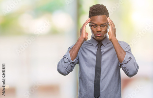 Young african american business man over isolated background with hand on head for pain in head because stress. Suffering migraine.