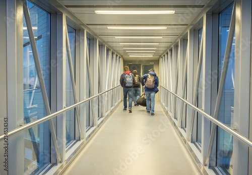 Passengers goes to airplane through jet bridge © rhzr