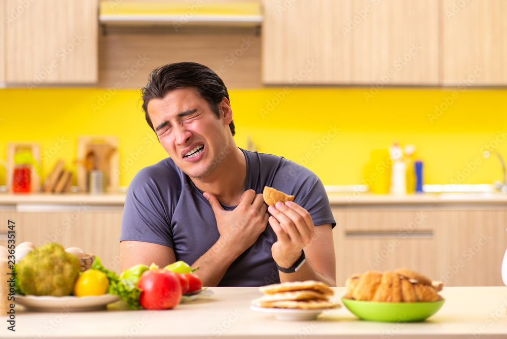 Man having hard choice between healthy and unhealthy food Man having hard choice between healthy and unhealthy food