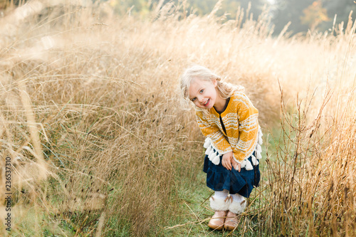 young girl playing in field