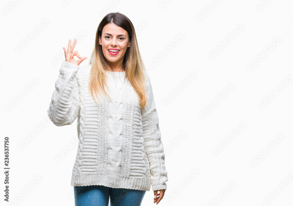 Young beautiful woman casual white sweater over isolated background smiling positive doing ok sign with hand and fingers. Successful expression. Young beautiful woman casual white sweater over isolated background smiling positive doing ok sign with hand and fingers. Successful expression.
