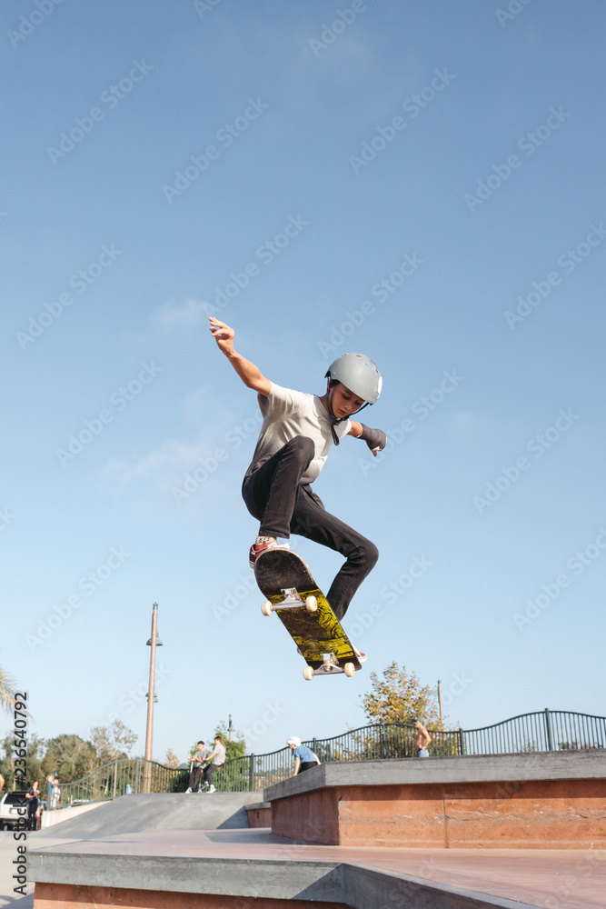 Kids having fun skating at skateboard park in the sunshine Kids having fun skating at skateboard park in the sunshine