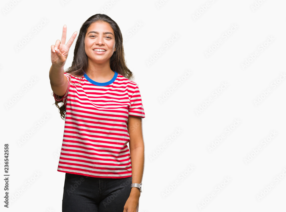 Young beautiful arab woman over isolated background smiling looking to the camera showing fingers doing victory sign. Number two. Young beautiful arab woman over isolated background smiling looking to the camera showing fingers doing victory sign. Number two.