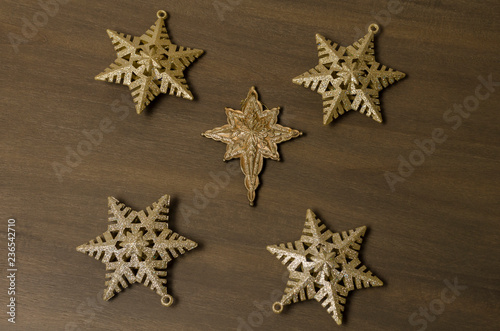 Golden stars against wooden background. Golden stars for Christmas decoration. Christmas background