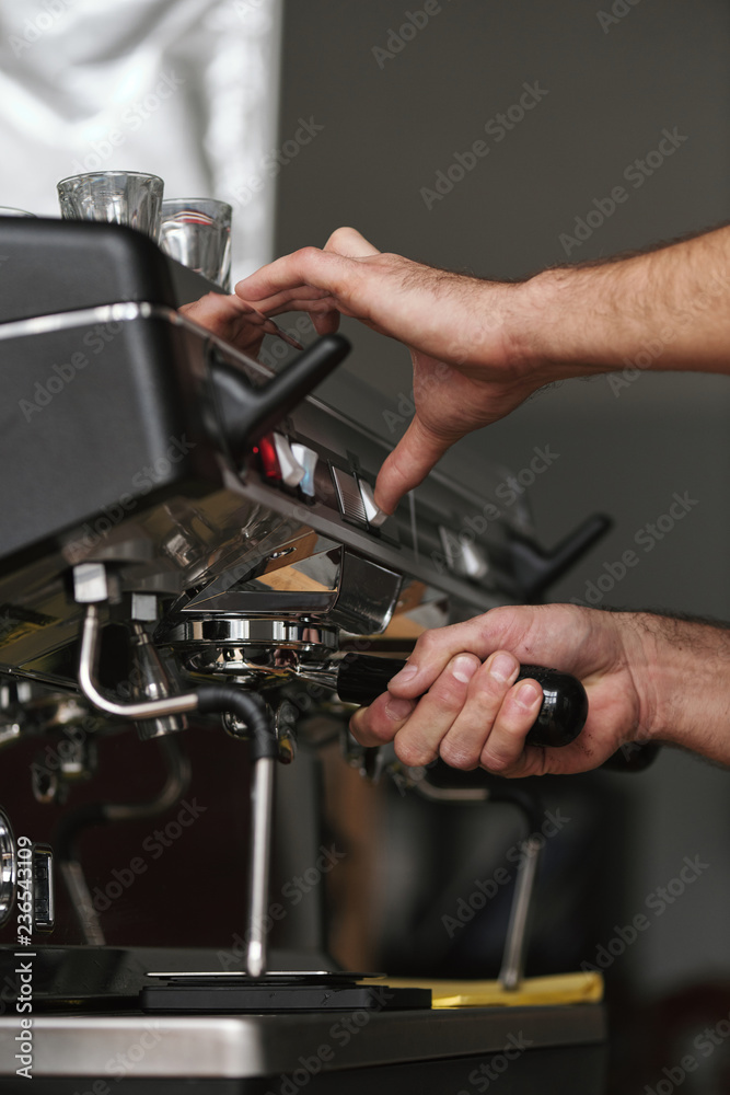 Bartender grinding coffee Bartender grinding coffee