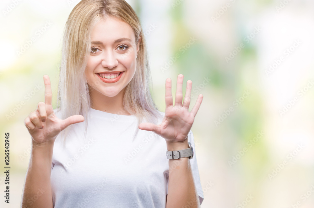 Young blonde woman over isolated background showing and pointing up with fingers number seven while smiling confident and happy. Young blonde woman over isolated background showing and pointing up with fingers number seven while smiling confident and happy.