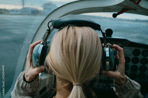 Female pilot putting on headset