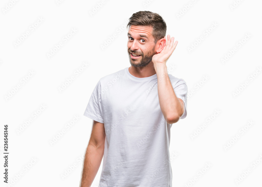 Young handsome man over isolated background smiling with hand over ear listening an hearing to rumor or gossip. Deafness concept. Young handsome man over isolated background smiling with hand over ear listening an hearing to rumor or gossip. Deafness concept.