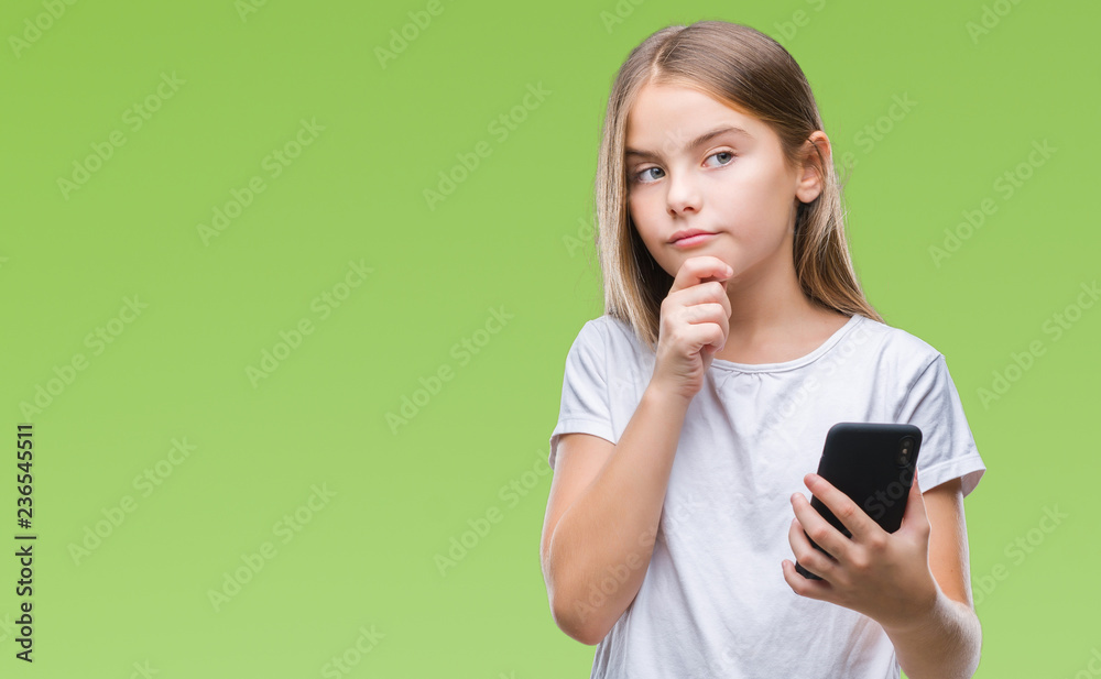 Young beautiful girl sending message texting using smarpthone over isolated background serious face thinking about question, very confused idea Young beautiful girl sending message texting using smarpthone over isolated background serious face thinking about question, very confused idea