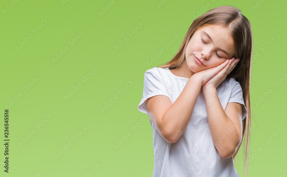 Young beautiful girl over isolated background sleeping tired dreaming and posing with hands together while smiling with closed eyes. Young beautiful girl over isolated background sleeping tired dreaming and posing with hands together while smiling with closed eyes.