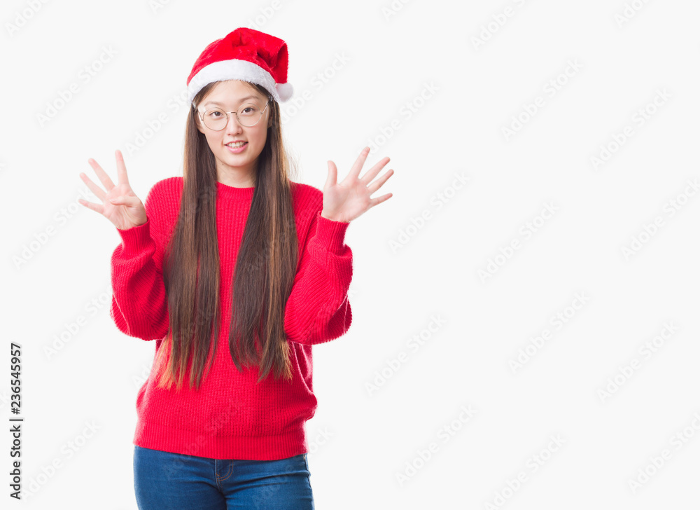 Young Chinese woman over isolated background wearing christmas hat showing and pointing up with fingers number nine while smiling confident and happy. Young Chinese woman over isolated background wearing christmas hat showing and pointing up with fingers number nine while smiling confident and happy.