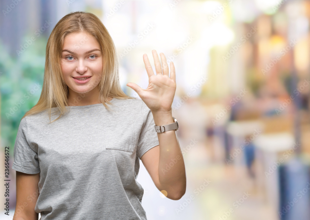 Young caucasian woman over isolated background showing and pointing up with fingers number five while smiling confident and happy.