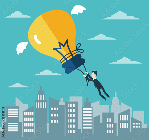 Business man try to catch flying idea