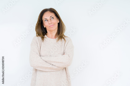 Beautiful middle age woman over isolated background smiling looking side and staring away thinking.