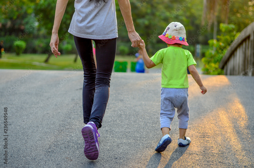Mother and her daughter walking excercise in park. Mother and her daughter walking excercise in park.