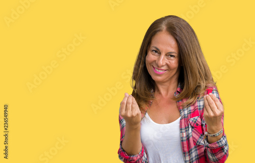 Beautiful middle age woman wearing over isolated background Doing money gesture with hand, asking for salary payment, millionaire business