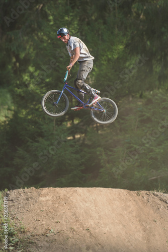 Male teenager catching air with BMX photo