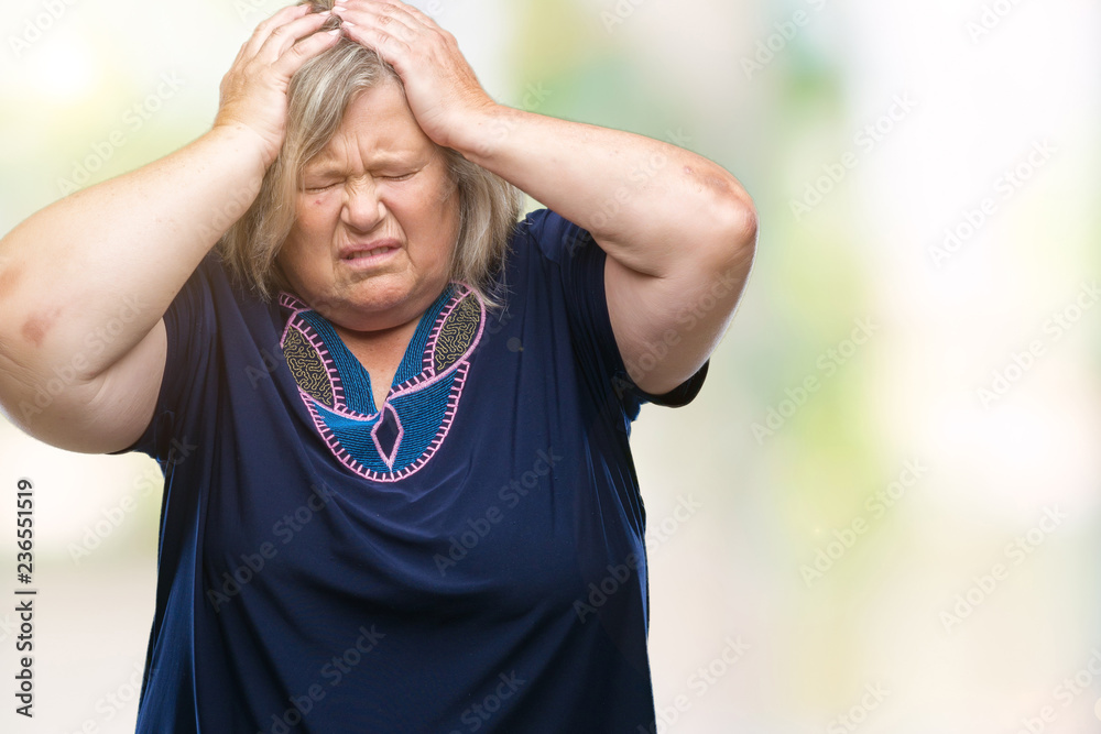 Senior plus size caucasian woman over isolated background suffering from headache desperate and stressed because pain and migraine. Hands on head.