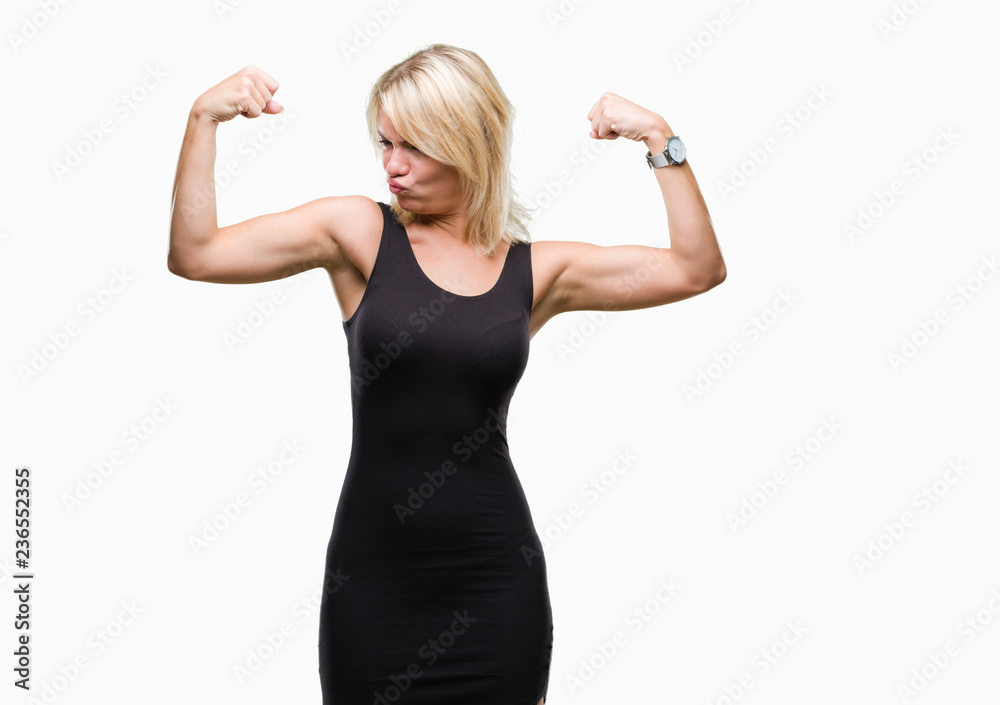 Young beautiful blonde attractive woman wearing elegant dress over isolated background showing arms muscles smiling proud. Fitness concept. Young beautiful blonde attractive woman wearing elegant dress over isolated background showing arms muscles smiling proud. Fitness concept.