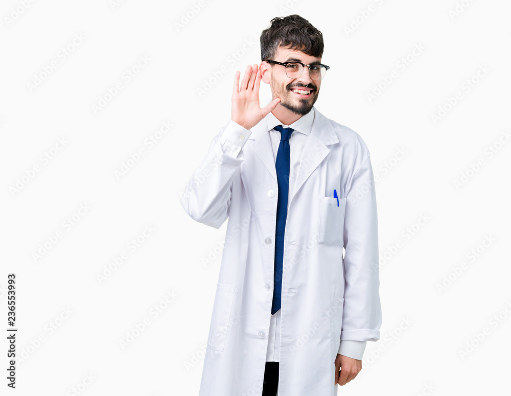 Young professional scientist man wearing white coat over isolated background smiling with hand over ear listening an hearing to rumor or gossip. Deafness concept. Young professional scientist man wearing white coat over isolated background smiling with hand over ear listening an hearing to rumor or gossip. Deafness concept.