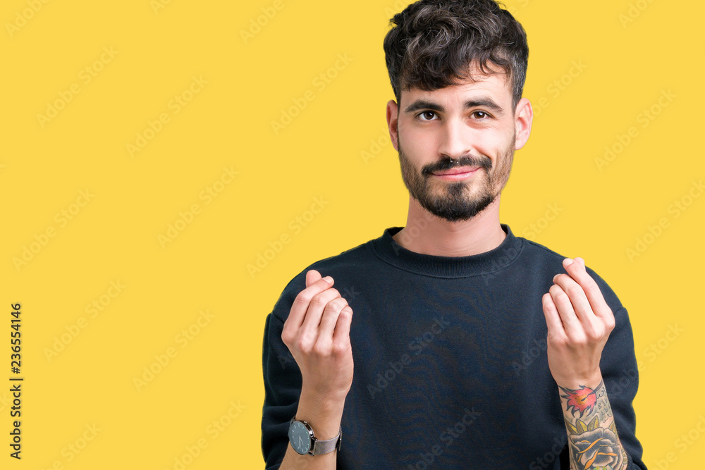 Young handsome man over isolated background Doing money gesture with hand, asking for salary payment, millionaire business Young handsome man over isolated background Doing money gesture with hand, asking for salary payment, millionaire business