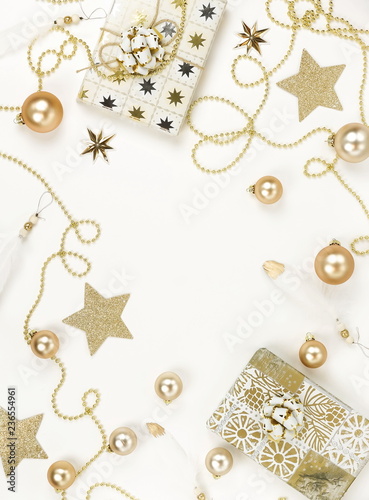 Christmas background from gold Christmas decorations on white table. Xmas composition of New Year's Christmas balls. Winter holiday concept.Flat lay. Top view. Copy space