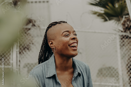 Joyful woman genuinely laughing toward camera photo