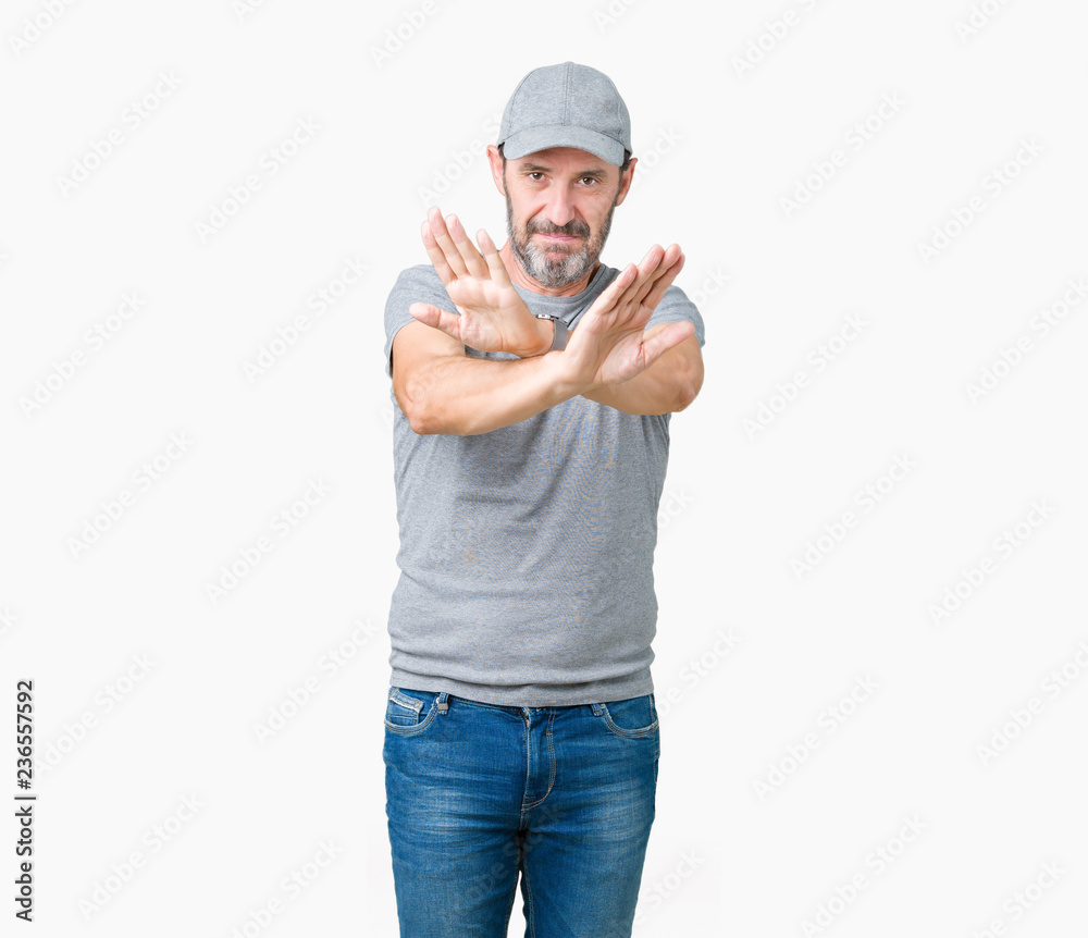 Handsome middle age hoary senior man wearing sport cap over isolated background Rejection expression crossing arms and palms doing negative sign, angry face Handsome middle age hoary senior man wearing sport cap over isolated background Rejection expression crossing arms and palms doing negative sign, angry face