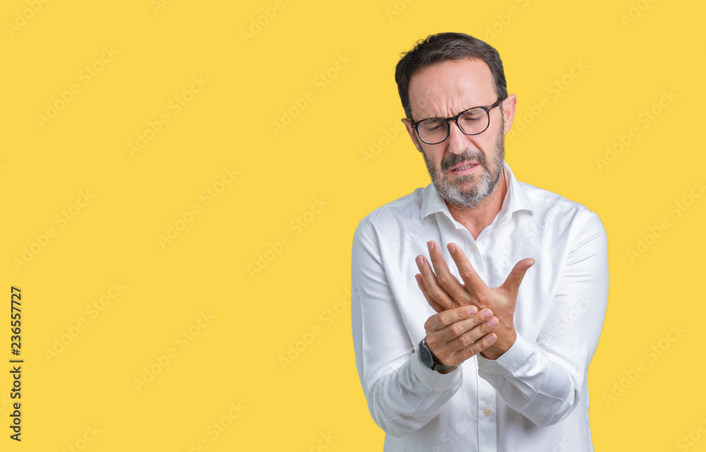 Handsome middle age elegant senior business man wearing glasses over isolated background Suffering pain on hands and fingers, arthritis inflammation Handsome middle age elegant senior business man wearing glasses over isolated background Suffering pain on hands and fingers, arthritis inflammation