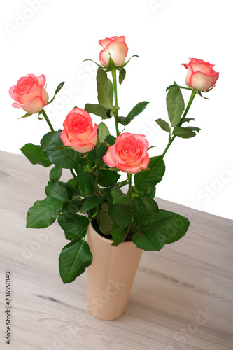 Beautiful bouquet of pink roses in ceramic vase.
