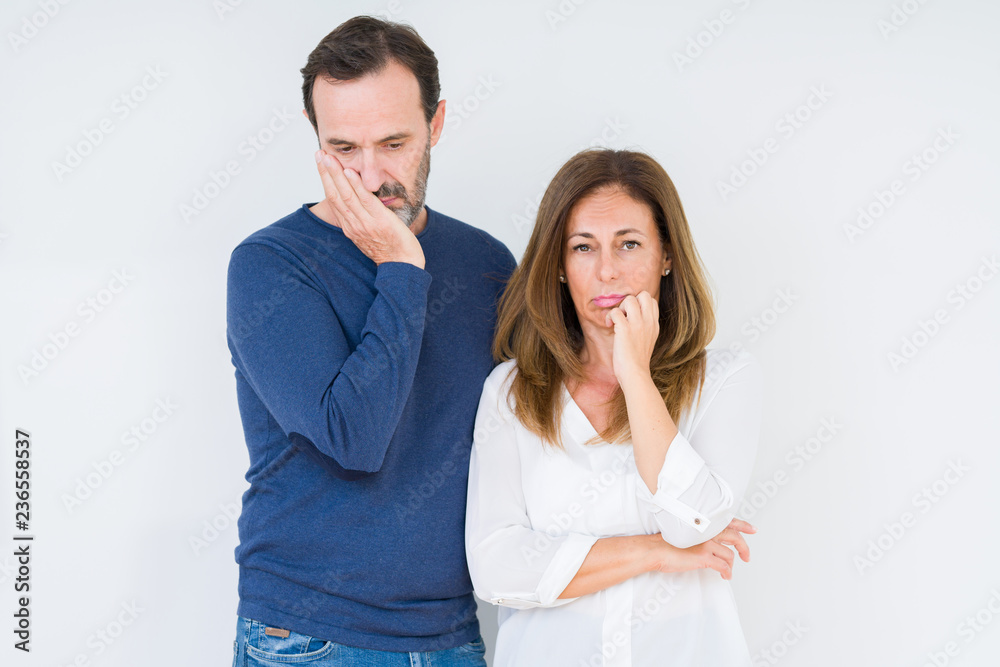 Beautiful middle age couple in love over isolated background thinking looking tired and bored with depression problems with crossed arms. Beautiful middle age couple in love over isolated background thinking looking tired and bored with depression problems with crossed arms.