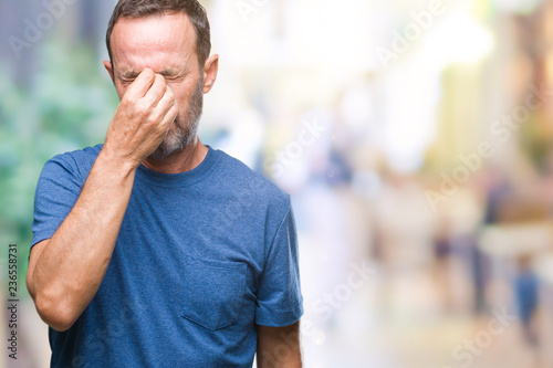 Middle age hoary senior man over isolated background tired rubbing nose and eyes feeling fatigue and headache. Stress and frustration concept.