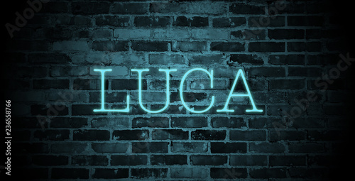 first name Luca in blue neon on brick wall