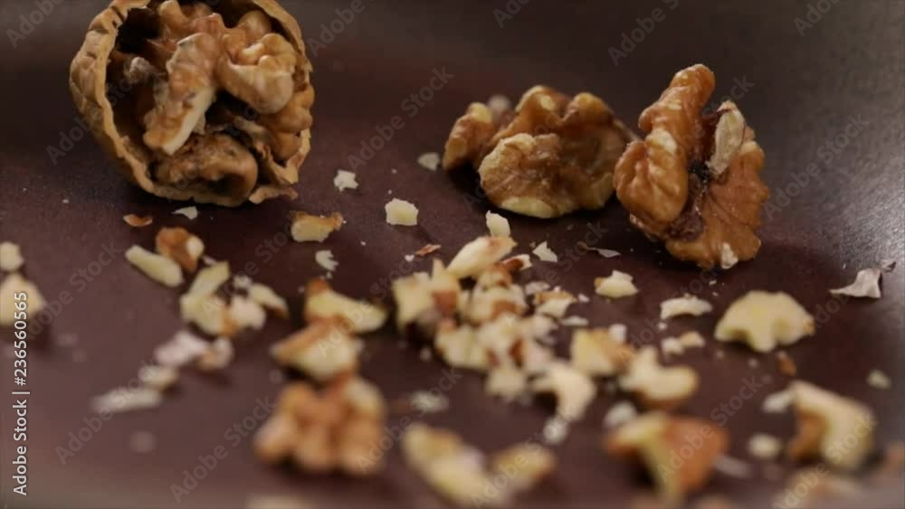 Chopped Walnuts Falling into a Pan, Closeup Chopped Walnuts Falling into a Pan, Closeup