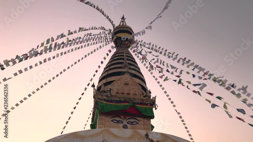 prayer flag around boudhanath stupa during sunset time photo