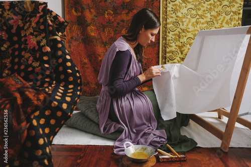 Female Artist Doing Batik Technique On The Piece Of Cloth photo