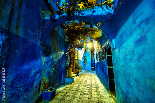 Chefchaouen , Morocco - November 2018: fantastic and mystical view of beautiful blue medina of Chefchaouen city at nighti n the light of lanterns. Morocco, North Africa © dsaprin