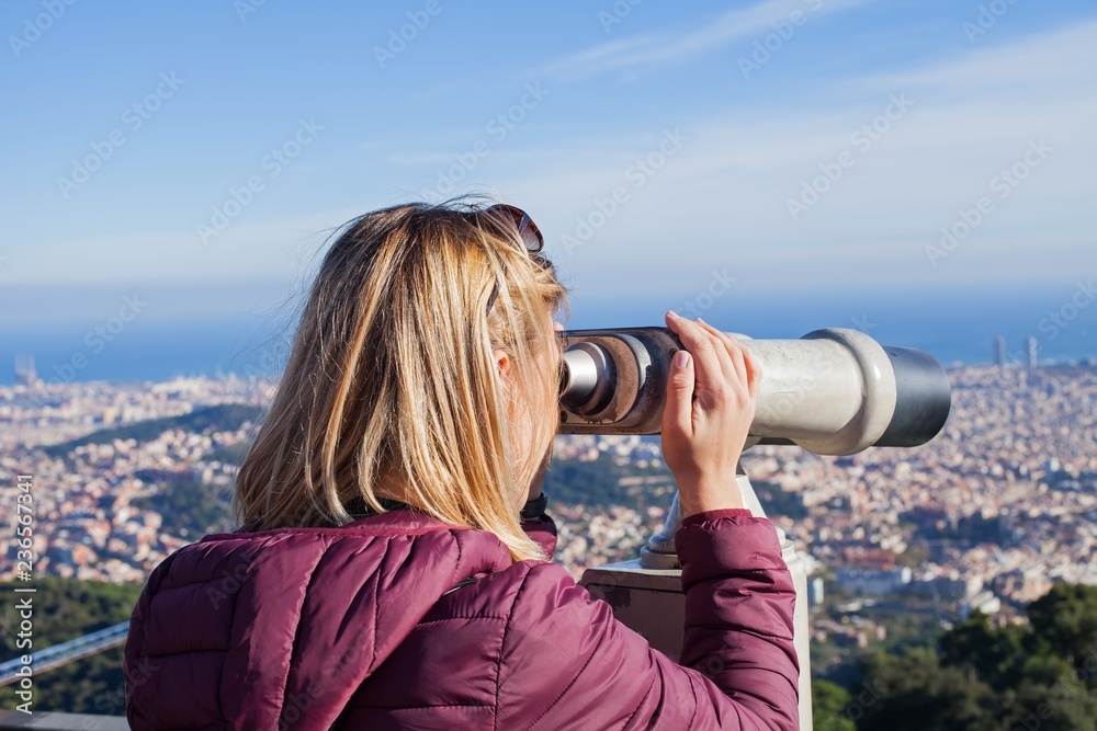 Blond woman admiring Barcelona from the top of Tibidabo