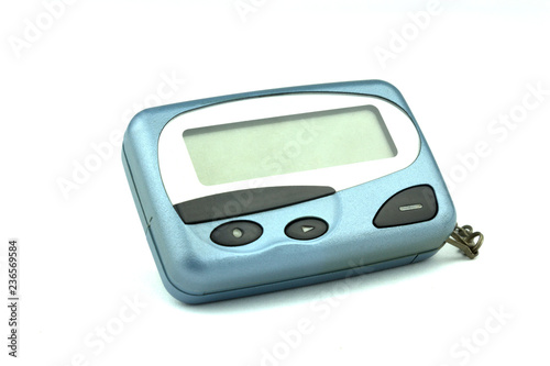 Close-up old a cyan metallic pager or beeper isolated with clipping path on white background.