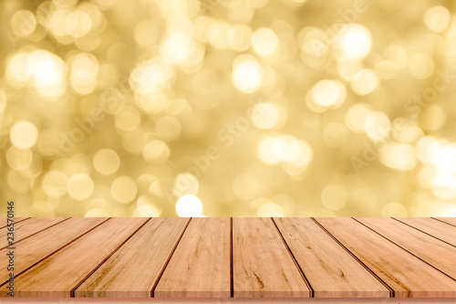 Wood table or wood floor with abstract gold bokeh background for product display